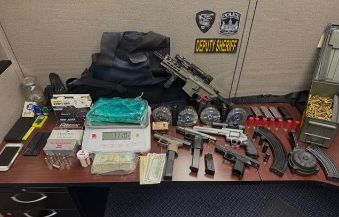 Athens Man Arrested After Drugs, Guns, and Cash Seized in Apartment Raid