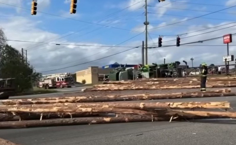 Log Truck Overturns in East Macon Crash, Scattered Logs Block Intersection