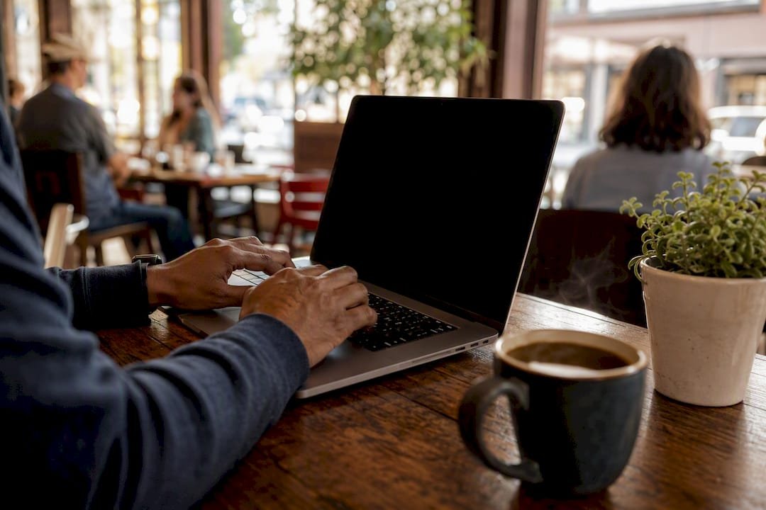Hands typing email on laptop